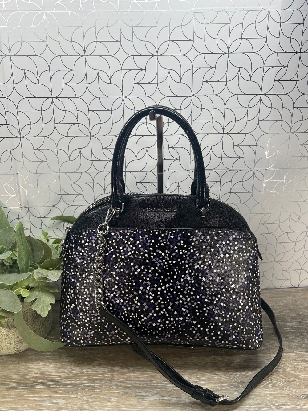 Michael Kors dome satchel featuring a striking purple and silver starburst